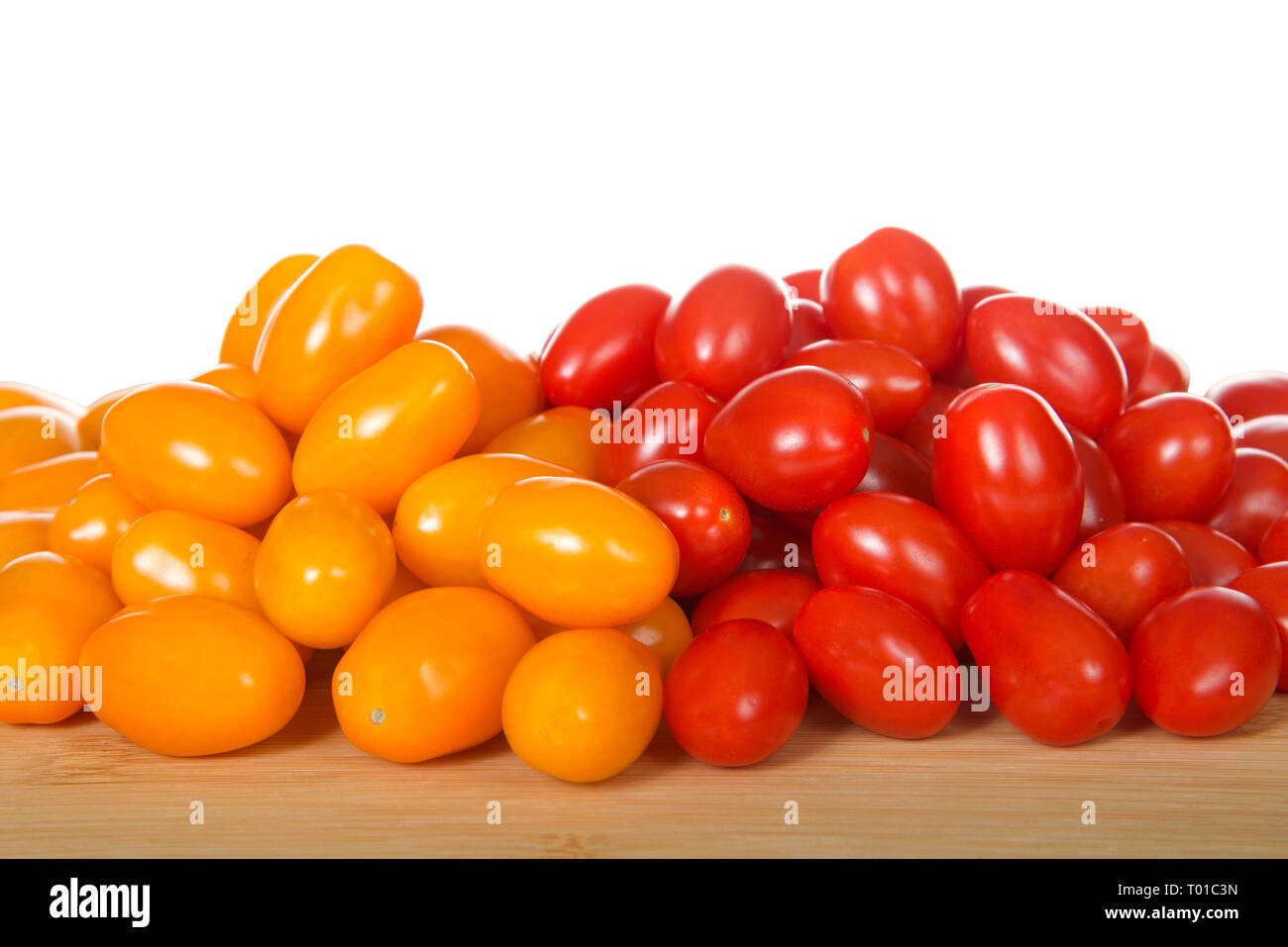Zima, an orange grape tomatoes next to Angel Sweet grape Tomatoes. Both great for salads or snacking. Stock Photo