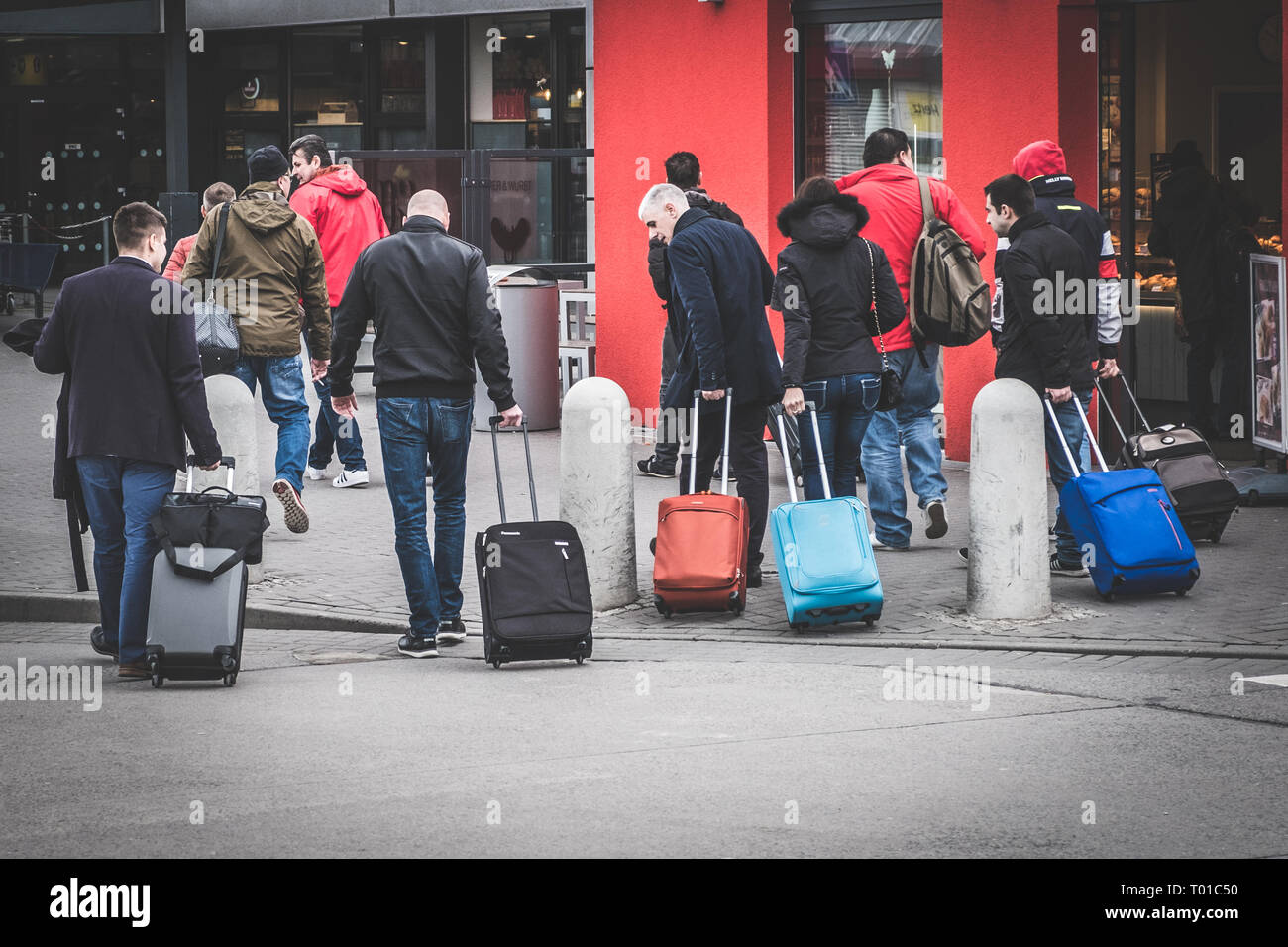 Berlin, Germany - march 2019: People with cabin luggage and trolley walking at airport Schoenefeld in Berlin Stock Photo