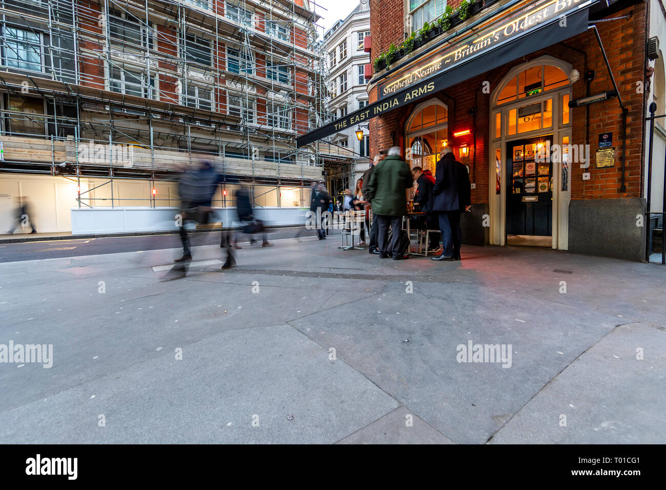 Drinkers and commuters mix on the street outside the East India Arms, 20 Fenchurch Street, London. Stock Photo