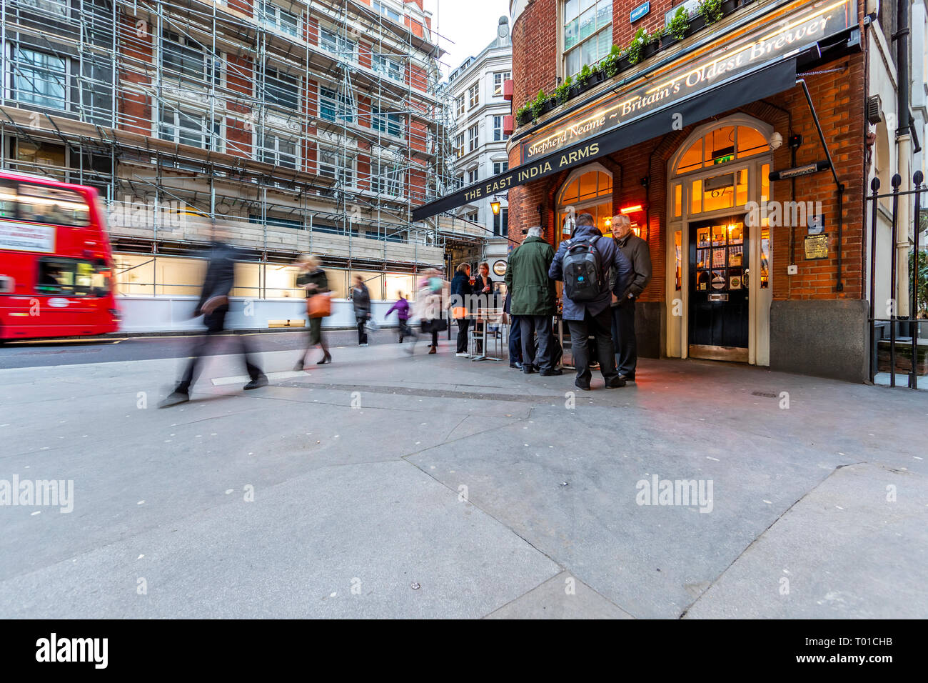 Drinkers and commuters mix on the street outside the East India Arms, 20 Fenchurch Street, London. Stock Photo