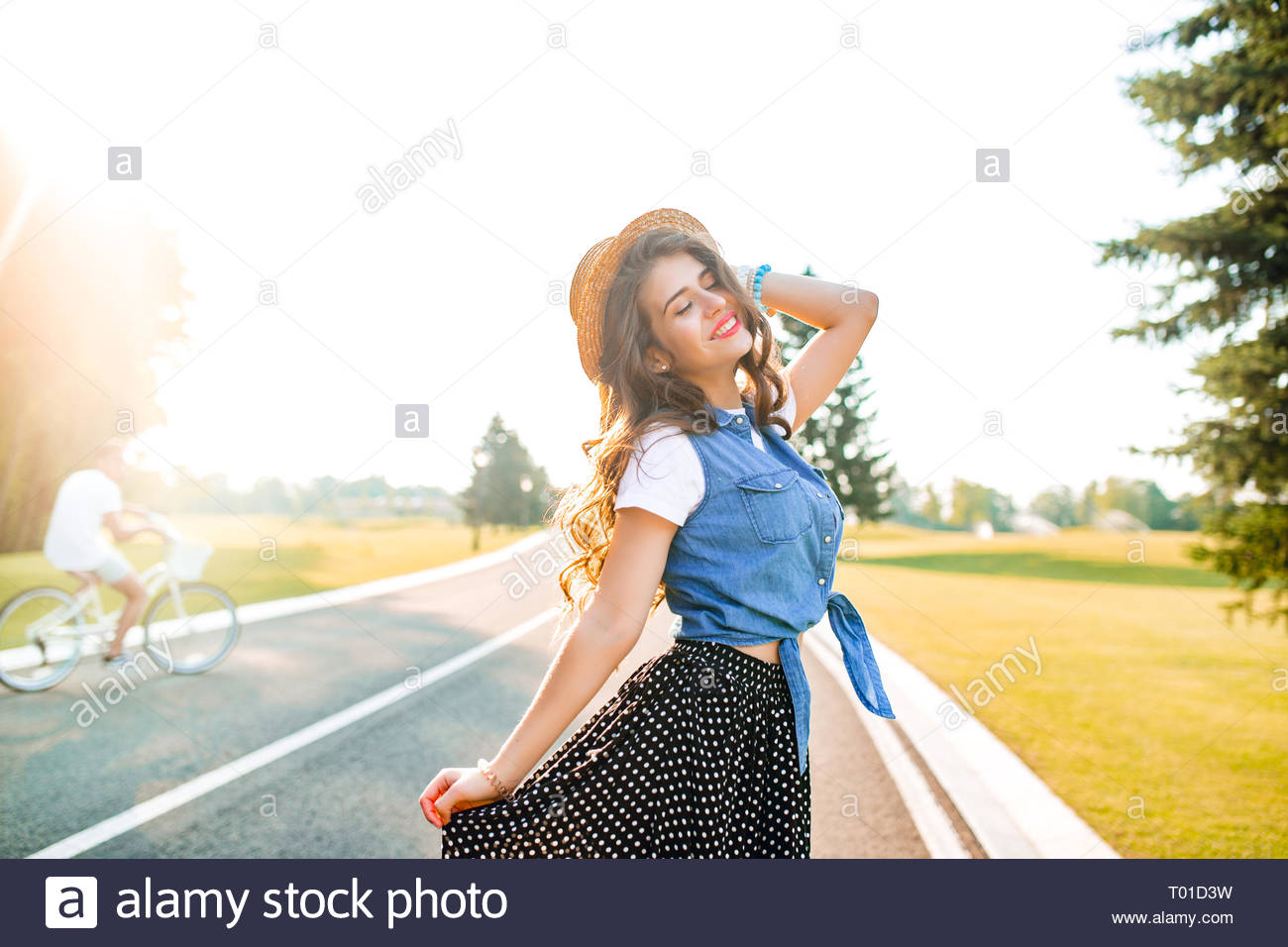 Cute Girl With Long Curly Hair In Hat Is Posing In Sunshine