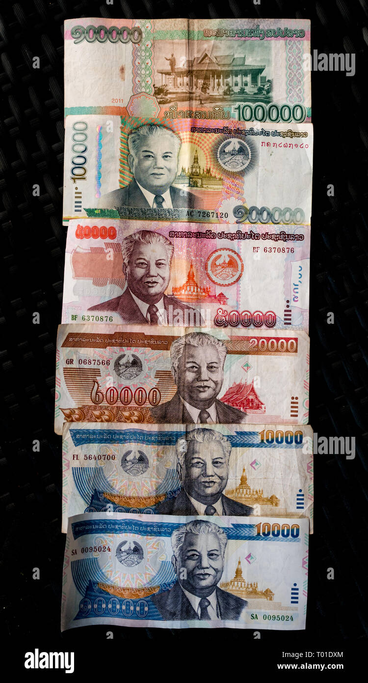 Variety of Laos Kip paper money banknotes on black background with President Kaysone Phomevihane Stock Photo