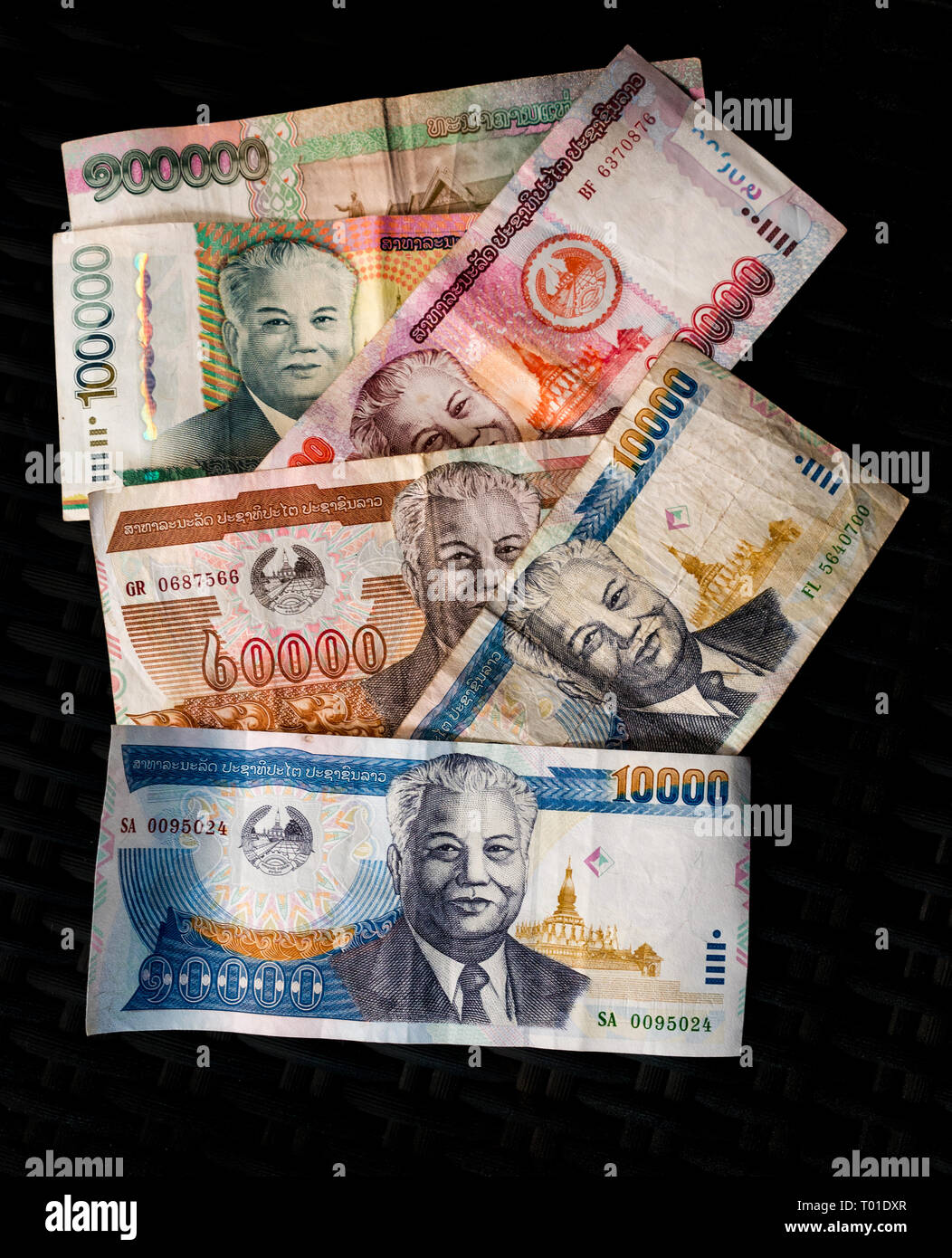 Variety of Laos Kip paper money banknotes on black background with President Kaysone Phomevihane Stock Photo
