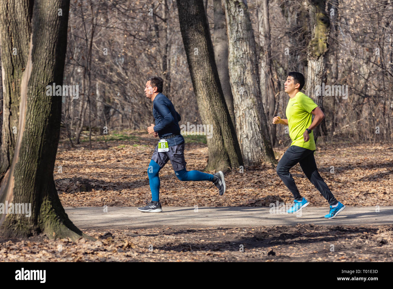 ALMATY KAZAKHSTAN - MARCH 16 2019: An unidentified man runs through a grove during the spring marathon in the city of Almaty, in a grove named after Stock Photo
