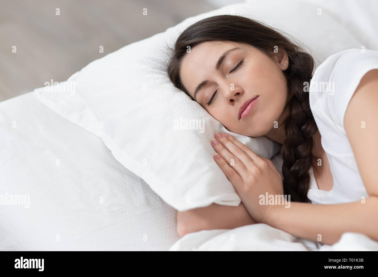 girl sleeping on white bed Stock Photo - Alamy