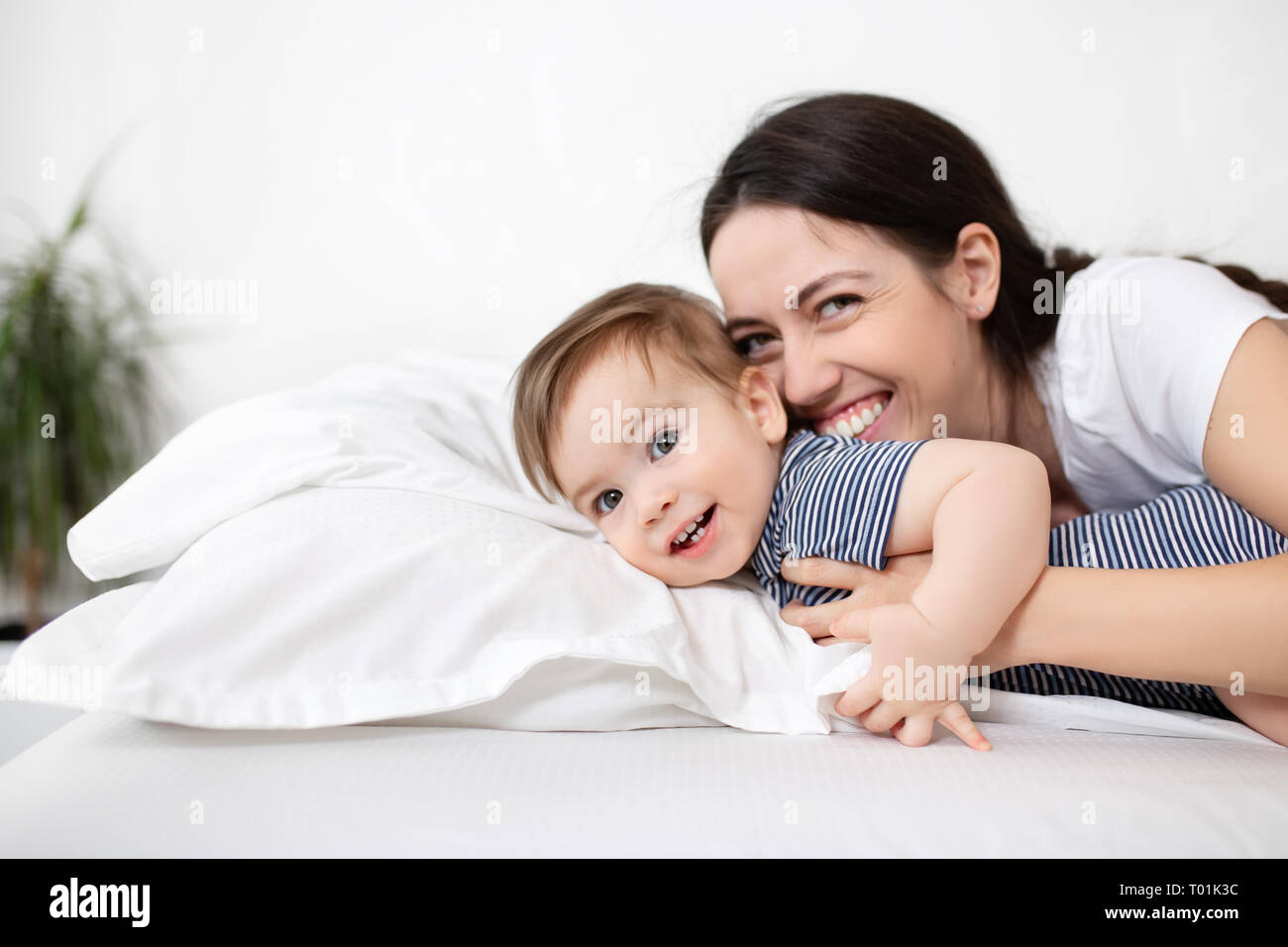 mother and baby boy on bed Stock Photo