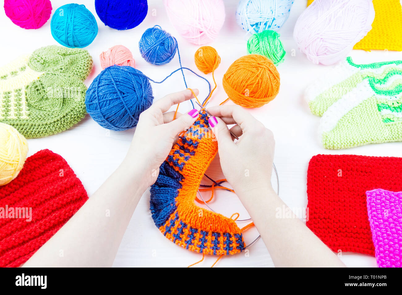 girl knits sock knitting needles on white background Stock Photo