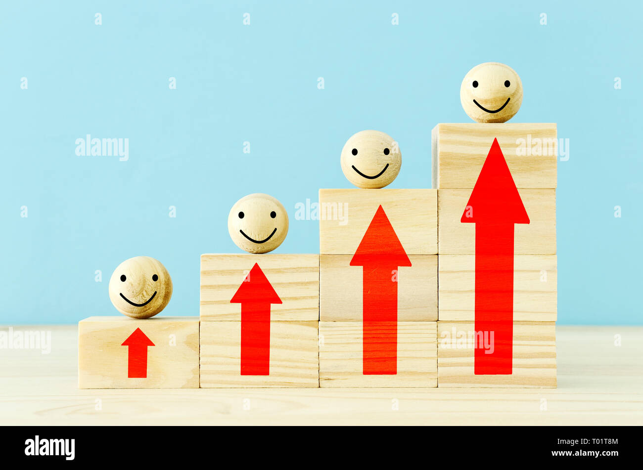 wooden blocks with smiling faces icons over table ,building a strong ...
