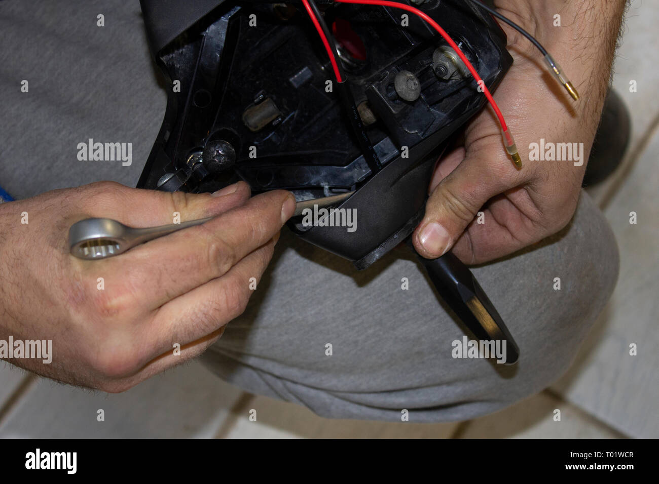 auto mechanic connects the wires in a motorcycle Stock Photo - Alamy