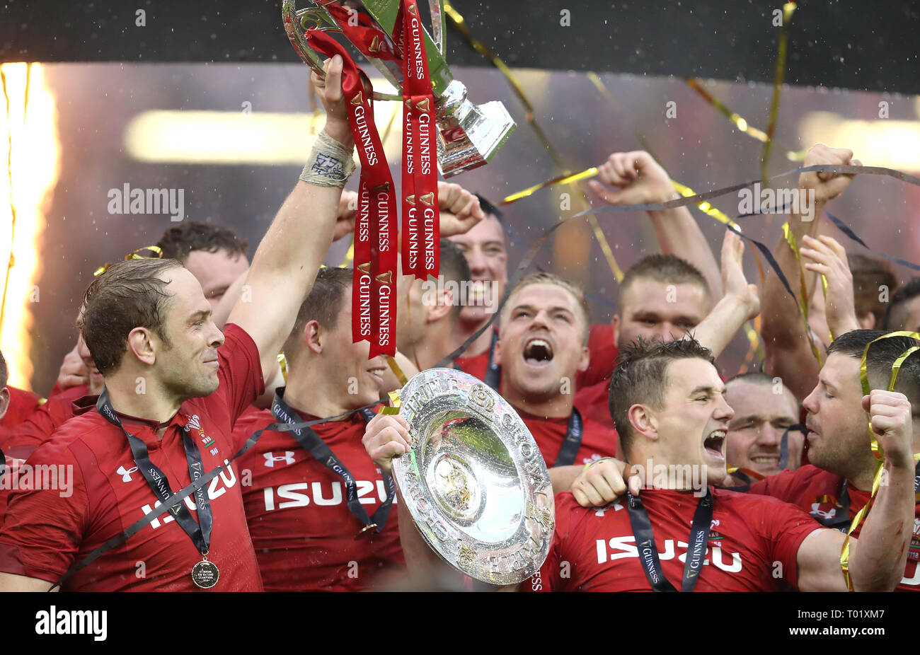 Wales lift the Six Nations Trophy and the Triple Crown trophy after the
