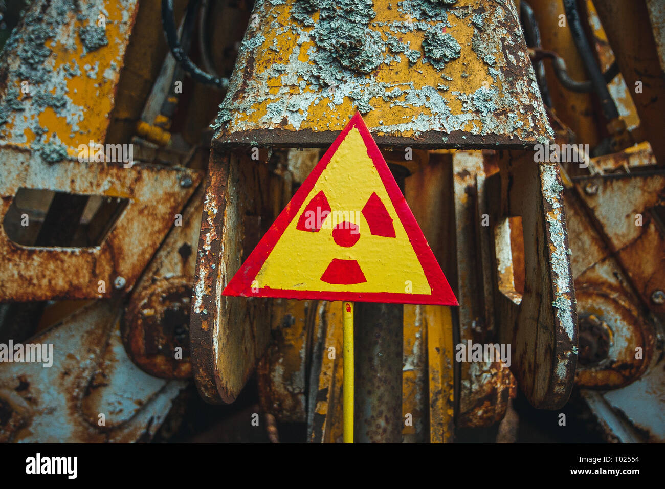 Radiation Sign - triangular warning yellow sign of radiation hazard in the zone of radioactive fallout in Pripyat city. Chernobyl exclusion zone Stock Photo
