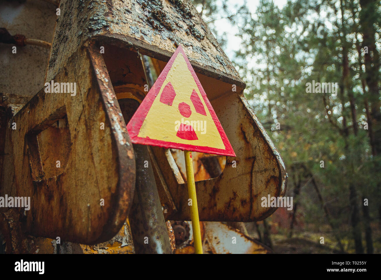 Radiation Sign - triangular warning yellow sign of radiation hazard in the zone of radioactive fallout in Pripyat city. Chernobyl exclusion zone Stock Photo