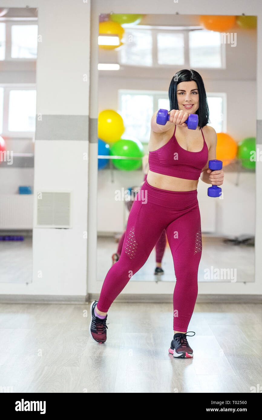 Adult sporty woman doing exercises with dumbbells. The concept of sports, a  healthy lifestyle, losing weight Stock Photo - Alamy