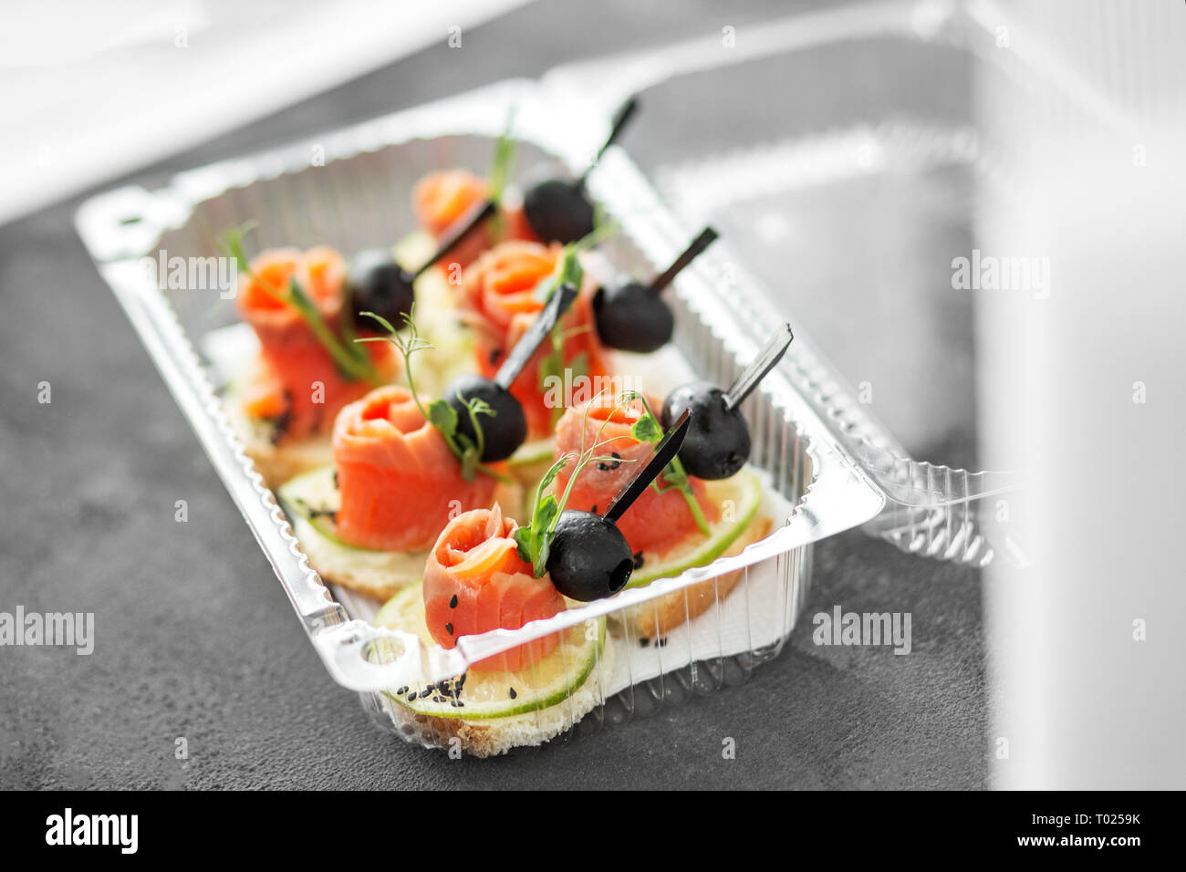 Delicious appetizers with salmon and lime and sesame. Lunch box. Concept of food, restaurant, catering, menu Stock Photo