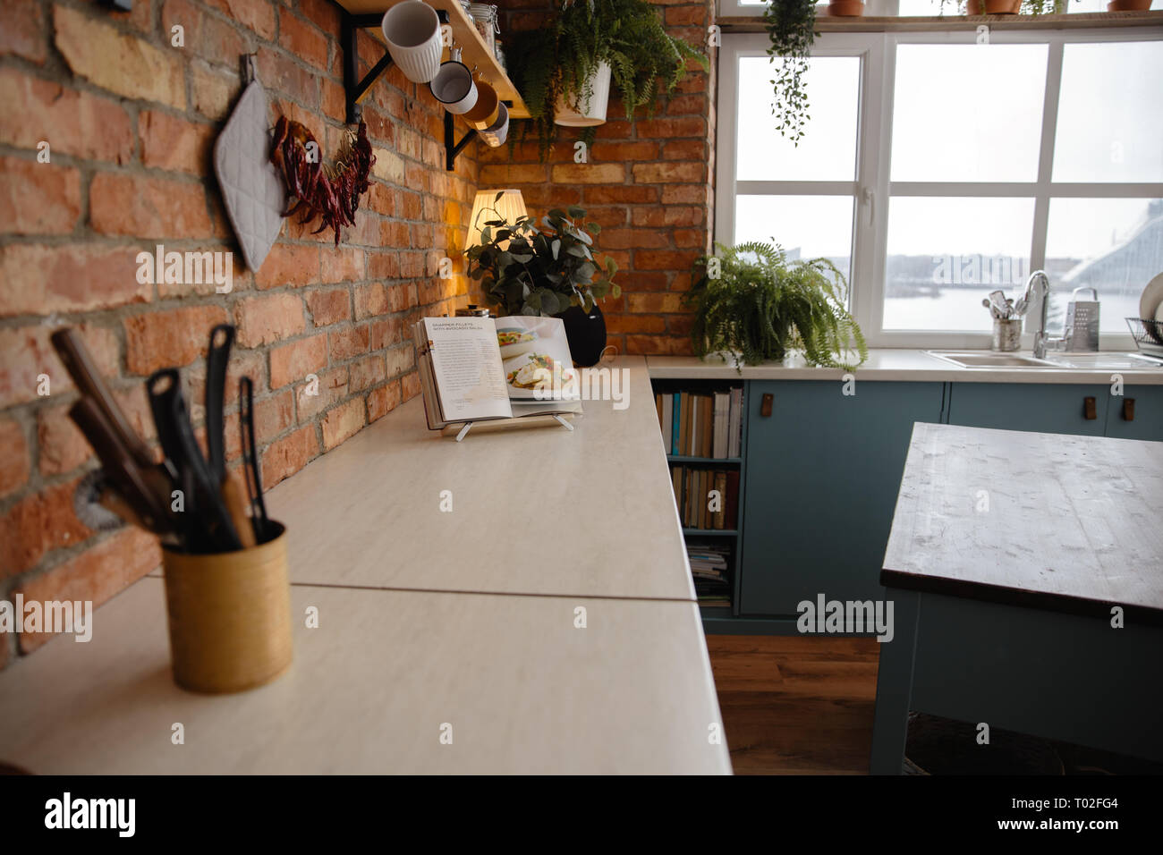 Kitchen loft with designed brick wall and a window facing The National