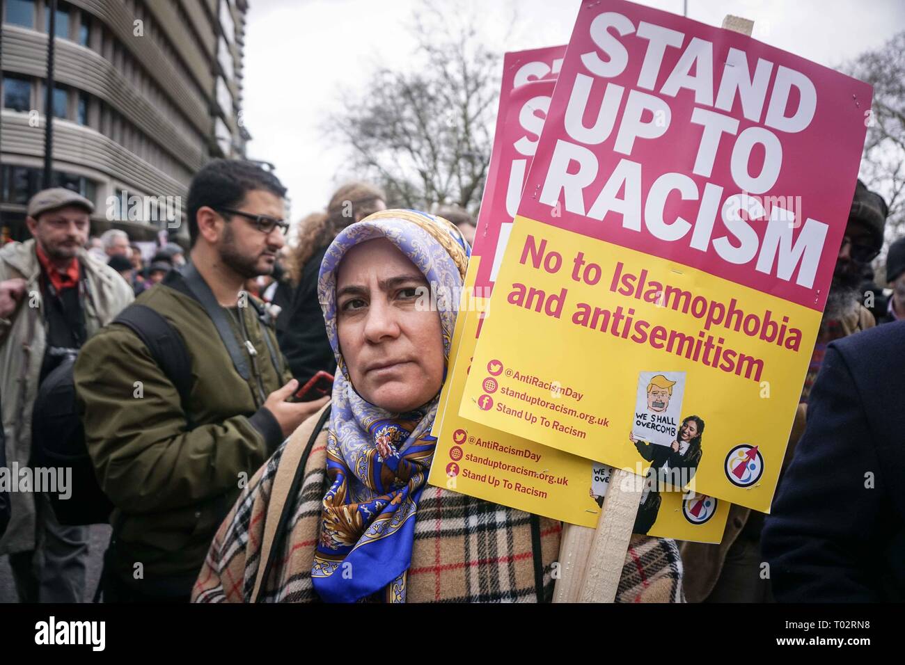 London, UK. 16th March 2019. A protester seen holding placards during an anti racist demonstration. Thousands of anti-racists groups took to the streets marking the World against Racism global day of action. Credit: SOPA Images Limited/Alamy Live News Stock Photo