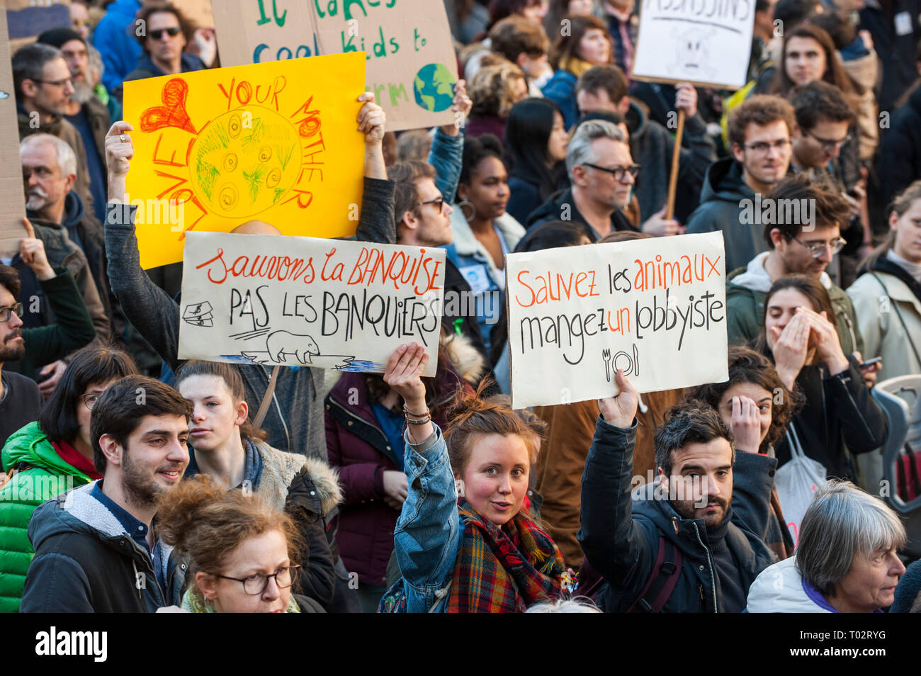 Paris, France. 16th March 2019. Protesters seen holding several placards during the March of The Century strike in Paris. Thousands of people demonstrated in the streets of Paris to denounce the inaction of the government about the climate change during a march called 'March of The Century' (La Marche du Siecle). Credit: SOPA Images Limited/Alamy Live News Stock Photo