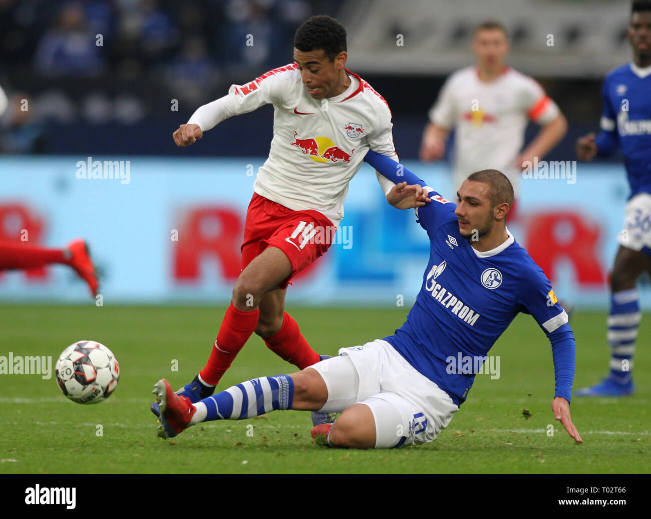 Gelsenkirchen, Germany. 16th March 2019. Ahmed Kutucu of Schalke 04, right,  and Tyler Adams of Leipzig are seen in action during the German Bundesliga  soccer match between FC Schalke 04 and RB