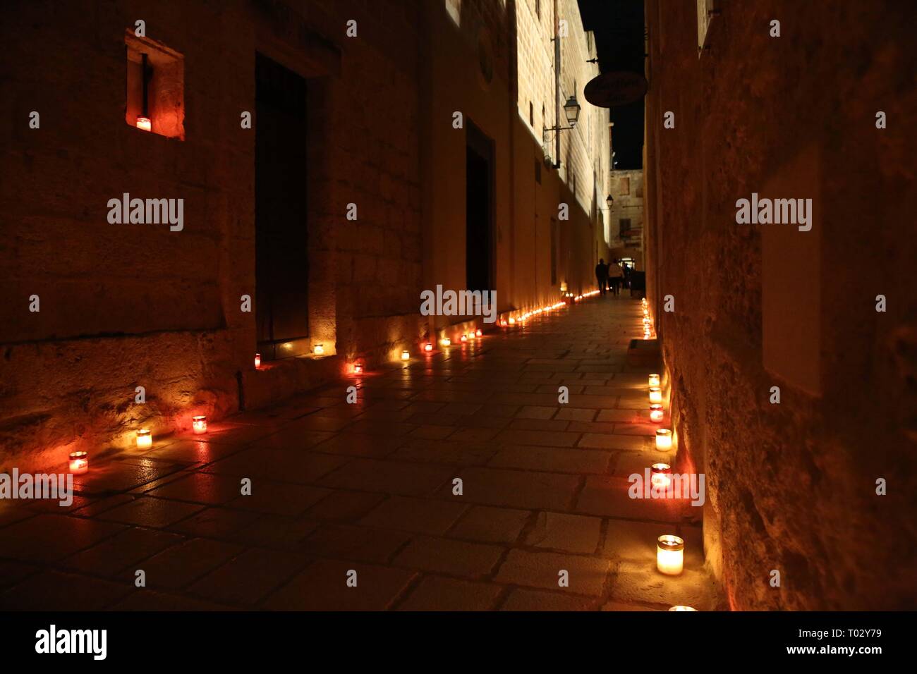 Valletta, Malta. 16th Mar, 2019. Candles are lit up on a narrow street