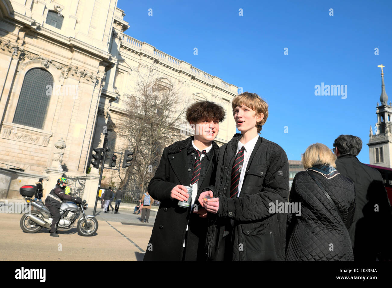 City of London school boys pupils students in winter coats and school uniform at lunchtime near St Pauls Cathedral in London England UK  KATHY DEWITT Stock Photo