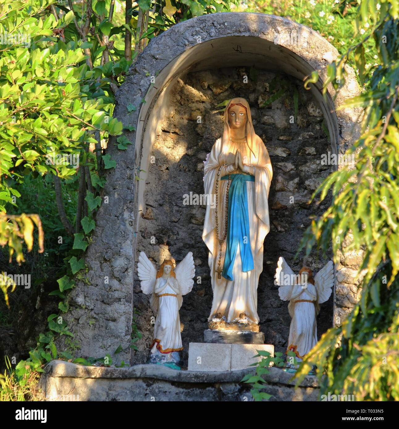 Statue of Virgin Mary in a grotto Stock Photo - Alamy