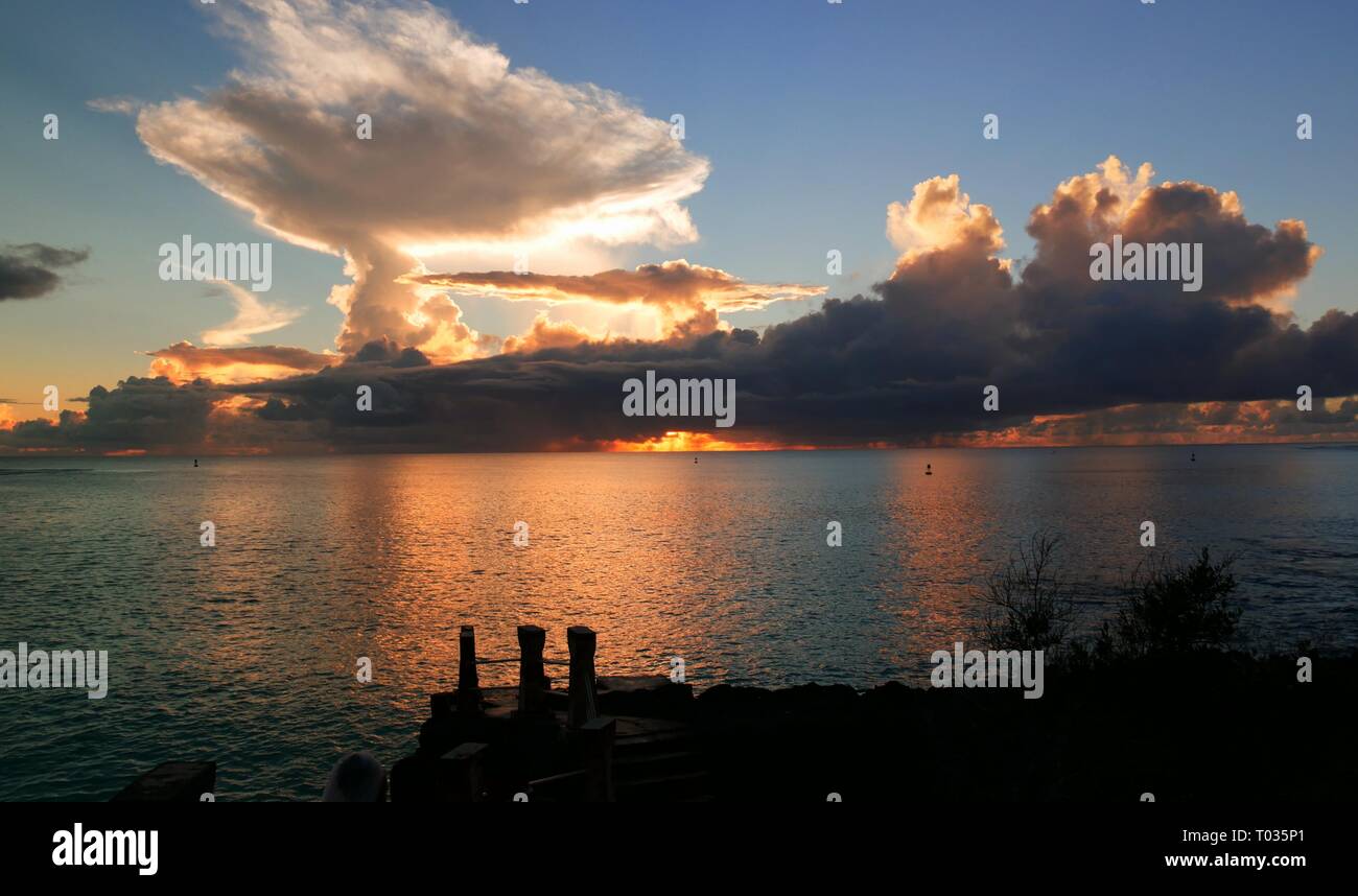 Amazing clouds at sunset reflected in the waters of Taga Beach,  Tinian, Northern Mariana Islands Stock Photo