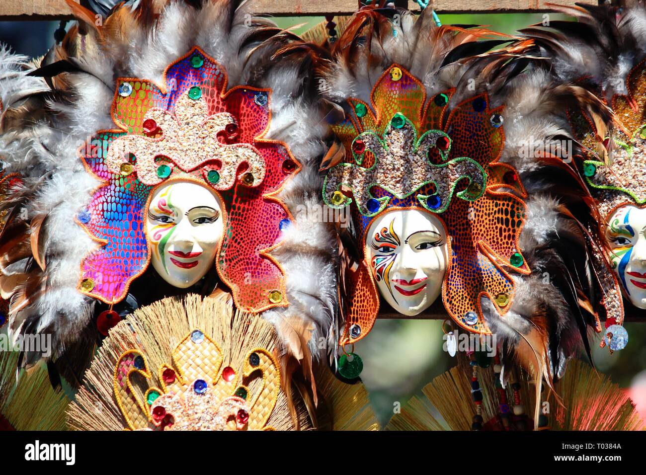 Masks of different attractive colors and feathers on display at the