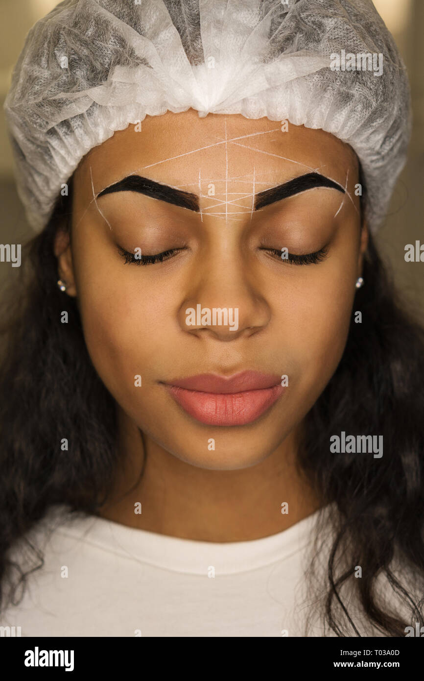 Beauty Procedure For Correcting Shape Of Eyebrows In Spa Salon Face Of Mixed Race Woman With Markup Of Perfect Shape Of Eyebrows Stock Photo Alamy