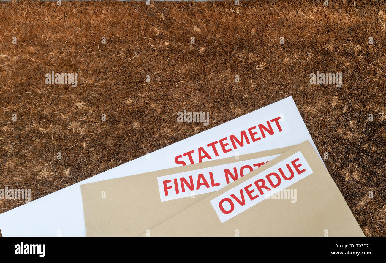 Overdue statements on a door mat. Financial crisis, trying to deal with debt. Stock Photo