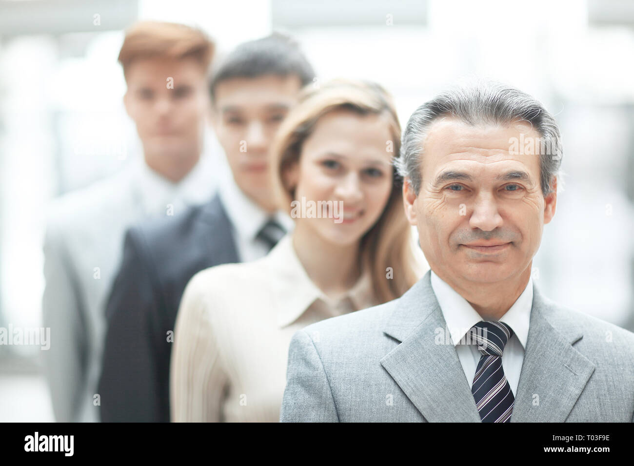 businessman standing in front of his business team on blurred office ...