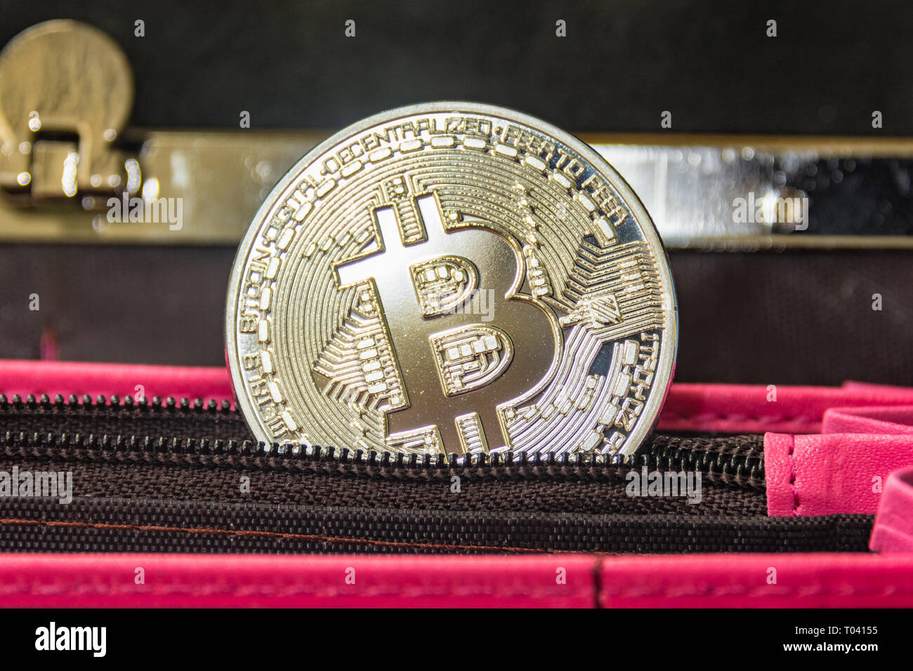 Crypto money metal coin in the pocket of open pinky wallet Stock Photo -  Alamy