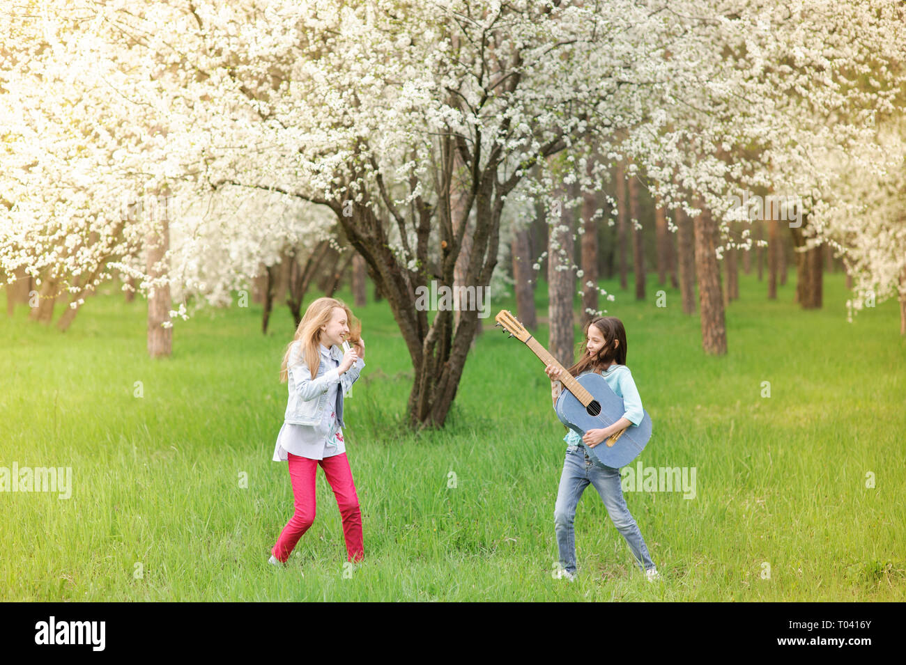 kids rock band of two funny little girls with vintage guitar and