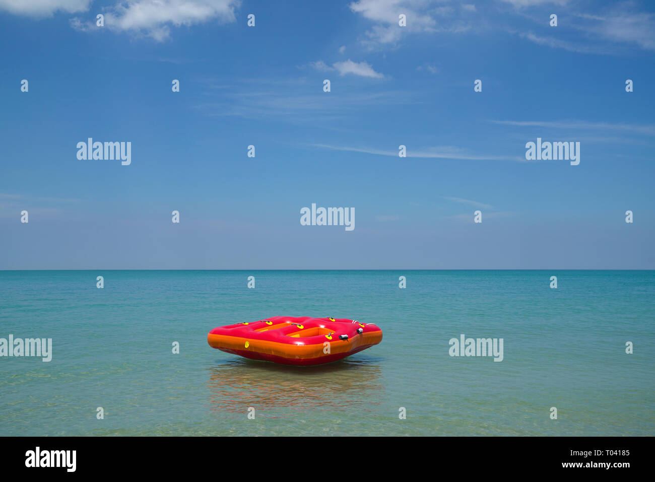Summer or vacation concept, Inflatable ring or lilo floating in the sea by the beach Stock Photo