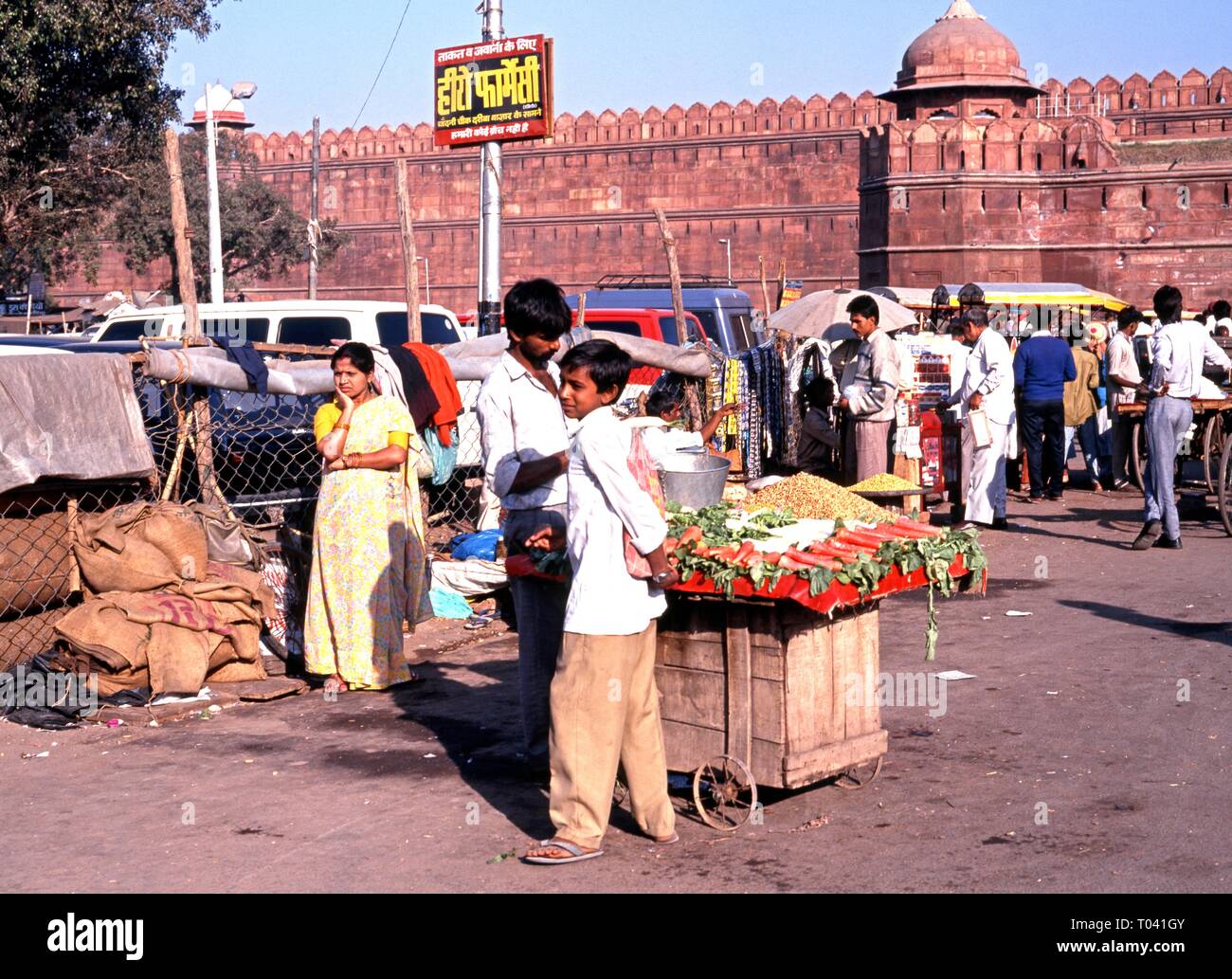 Roadside vegetable stall and seller outside the Red Fort, Delhi, Delhi Union Territory, India. Stock Photo