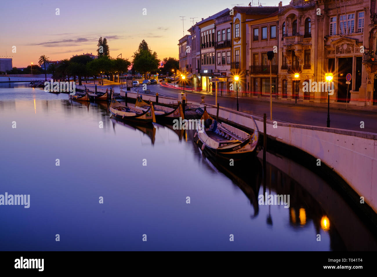 Canal in Aveiro with tourist boats parked for night  during blue hour. Long exposure. In Aveiro Portugal Stock Photo