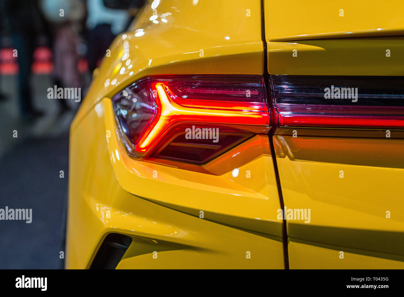 Car headlight with backlight. Exterior detail.Yellow color luxury car