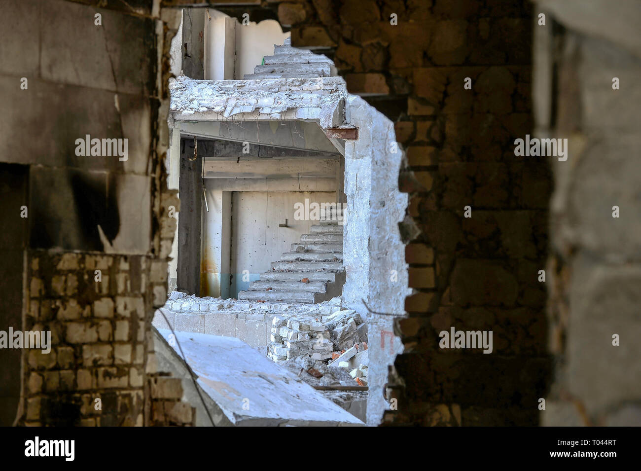 View From Inside Through The Broken Wall To The Next Destroyed Building With A Bare Flight Of Stairs Stock Photo Alamy