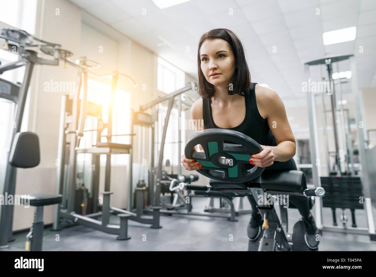 Young beautiful athletic woman brunette doing fitness exercises in the gym. Fitness, sport, training, people, healthy lifestyle concept Stock Photo