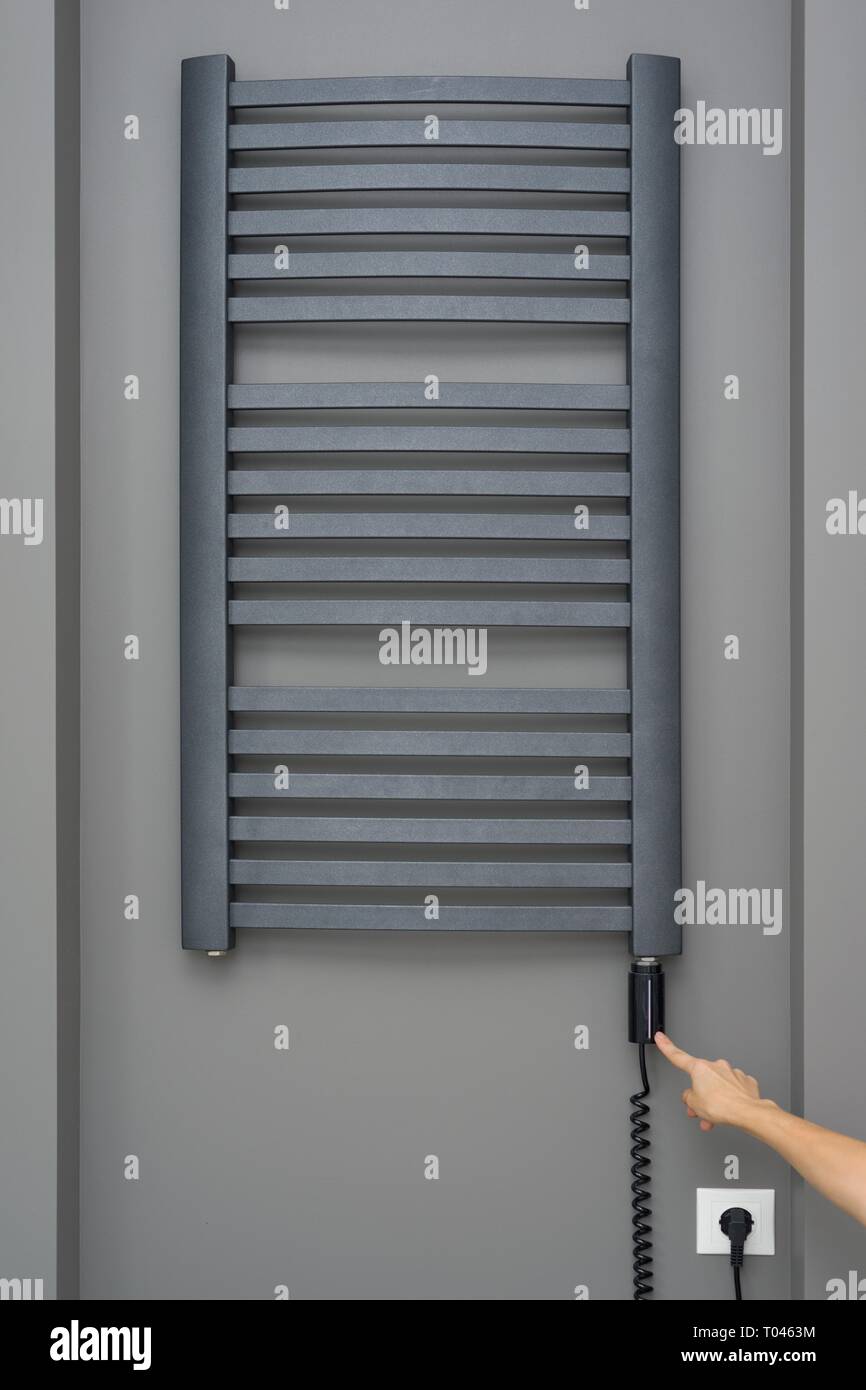 Closeup interior elements of bathroom, towel radiator. Gray electric