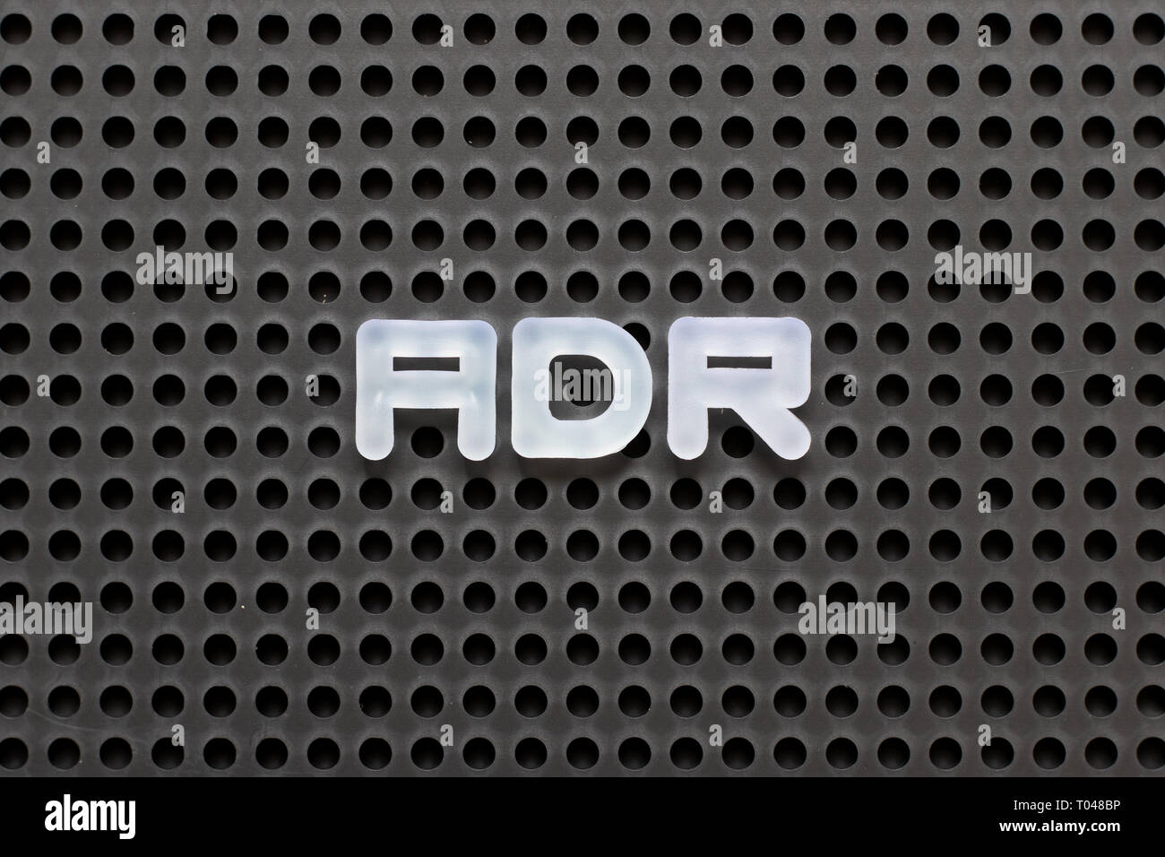 Black Color Pegboard With White Letter In Word ADR Abbreviation Of Adverse Drug Reaction Stock 