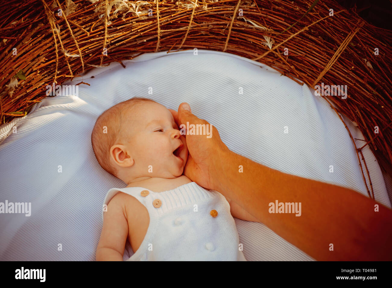 Family love. Baby sleep in bed. Mother touch newborn baby with love