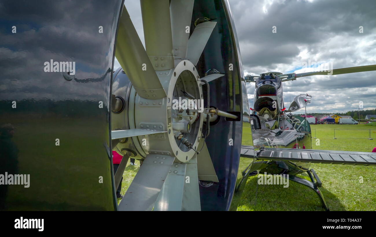 The closer look of the rotor of the helicopter parked outside the green ...