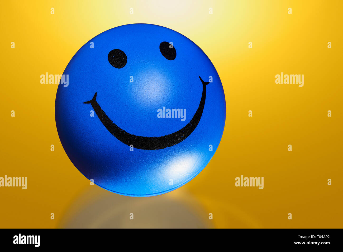 Round ball with smile isolated on color background out of focuss Stock Photo