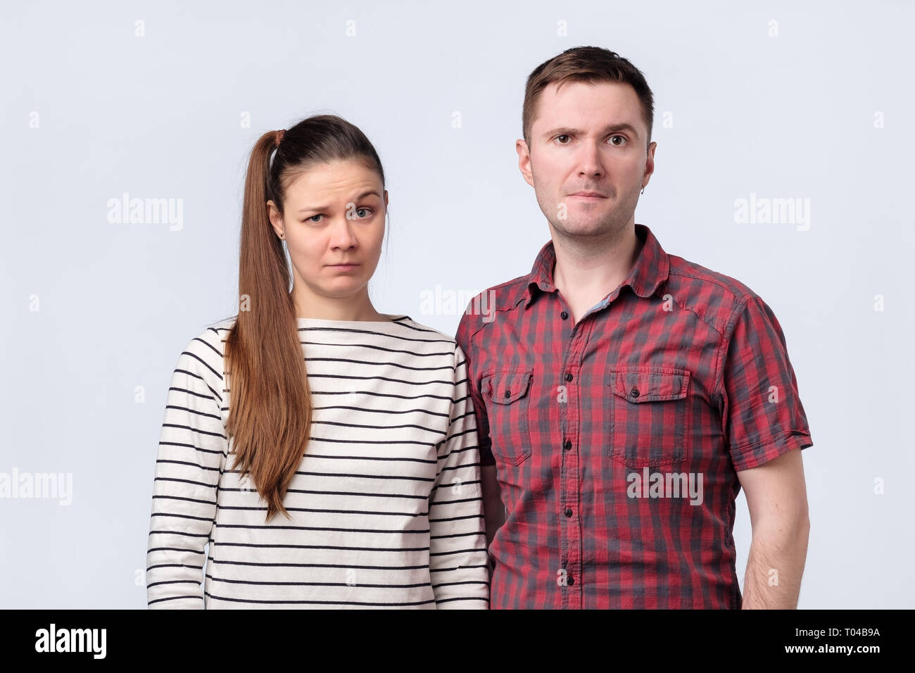 Young confused couple looking puzzled at camera. Stock Photo