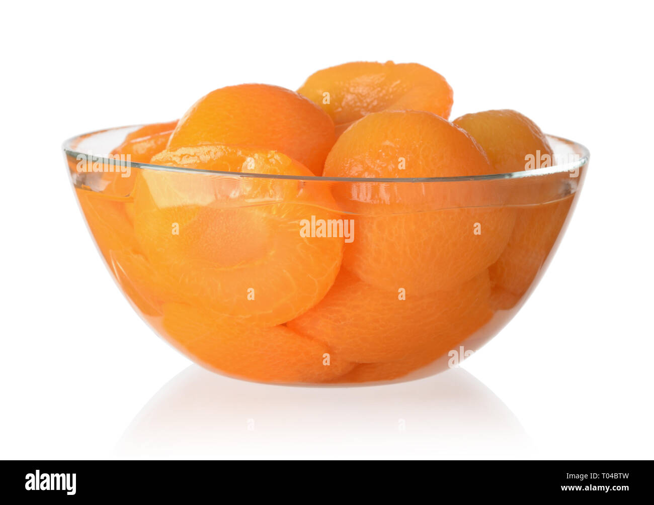 Canned peaches in a glass bowl isolated on white background Stock Photo