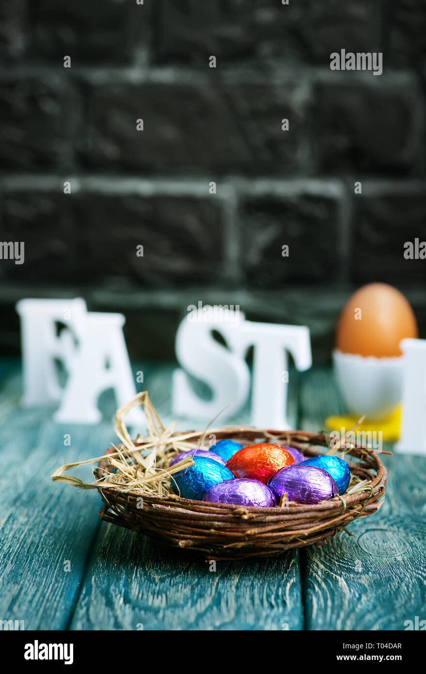 color easter eggs in nest and on a table Stock Photo