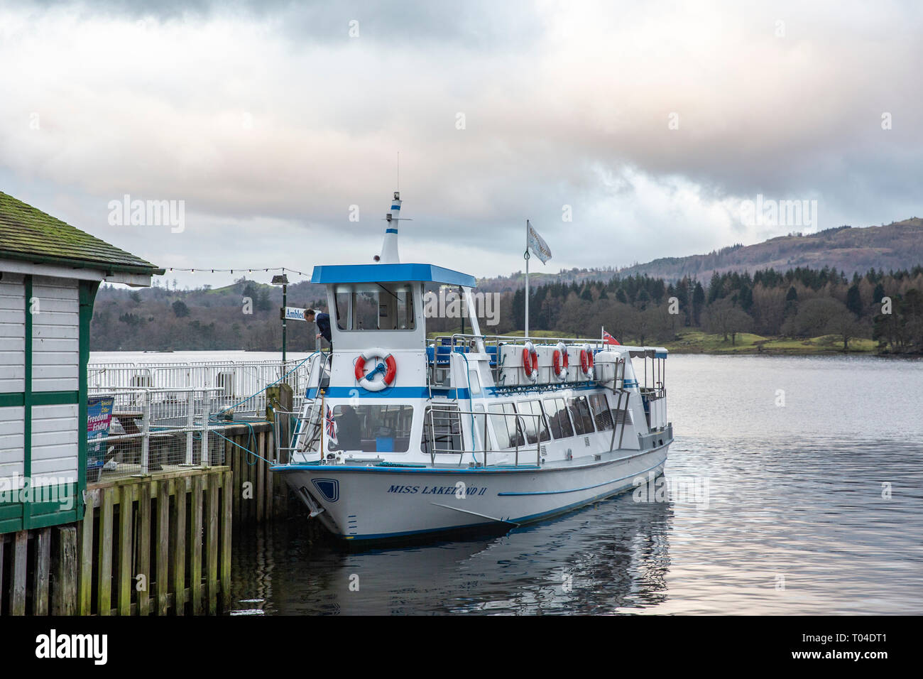 Skipper aboard Miss Lakeside sightseeing boat at Ambleside Pier on lake