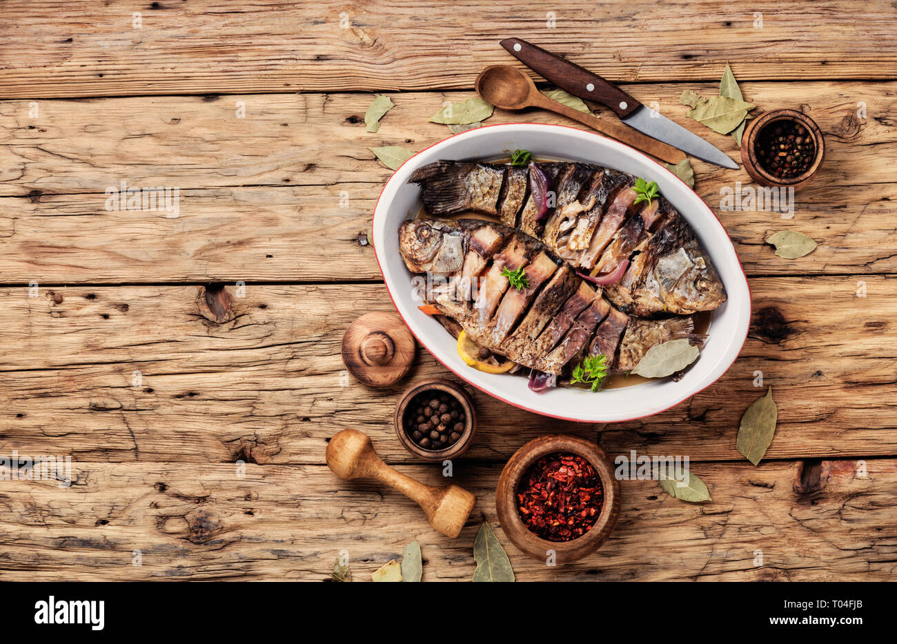 Loaded Fish Baked fish loaded with citrus, herbs and spices in baked fish Stock ...
