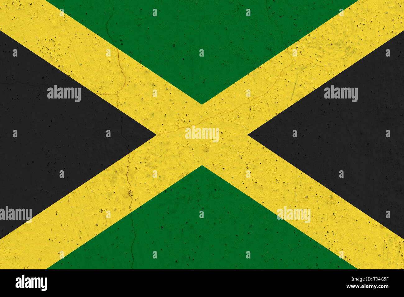 Jamaica flag on concrete wall. Patriotic grunge background. National flag of Jamaica Stock Photo
