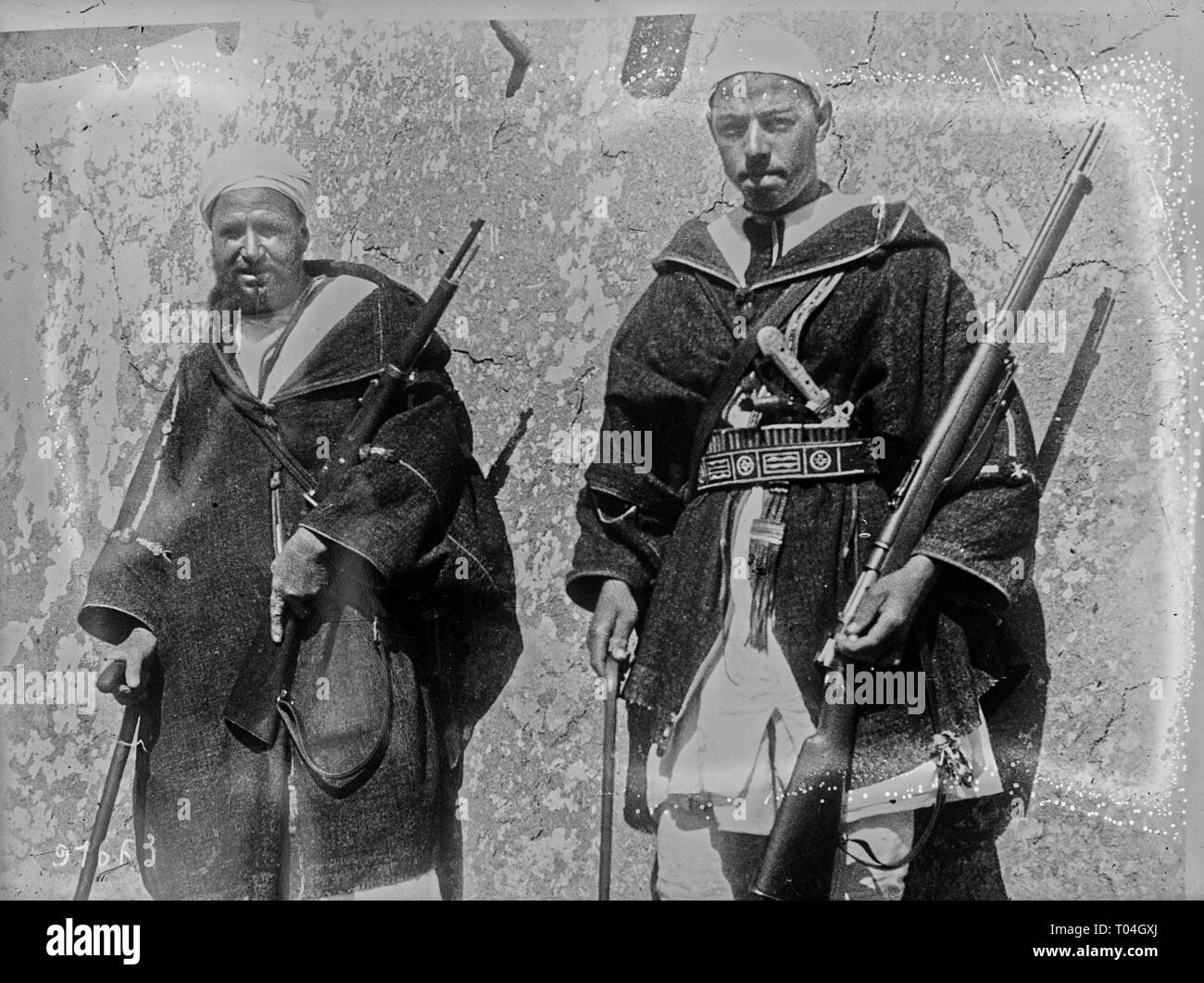 Riffian leader Kaid Sarkash with his son, wearing Mauser guns stolen from Spaniards, 1924, Location National Library of France Stock Photo